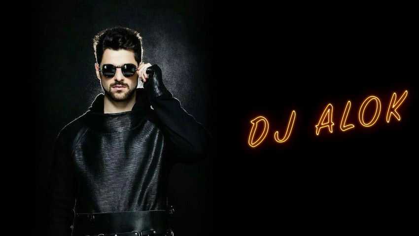 8K Black Background Dj Alok With Orange Glowing Text Wallpaper Background