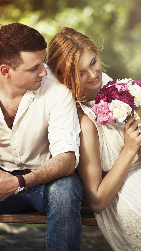 Couple Sitting On Bench Phone Wallpaper